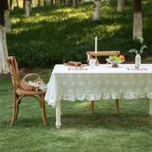 Farmhouse-style cotton lace tablecloth on a wooden table