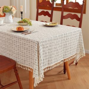 100% cotton printed tablecloth with tassel trim on wood dining table
