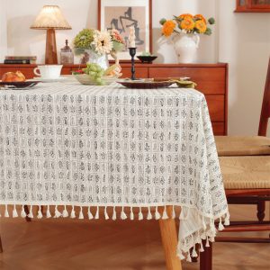 Close-up of floral print and cotton tassel edge detail