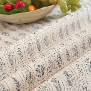 Elegant printed cotton tablecloth draped over farmhouse table