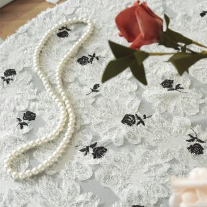 Close-up of floral embroidery on natural cotton tablecloth