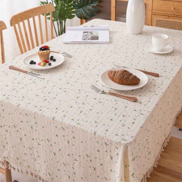 Close-up of woven cotton texture and fringe edge on elegant tablecloth