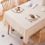 Close-up of yellow floral cotton tablecloth with handmade tassel fringe – Kioscr home decor