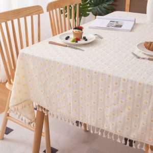 Natural cotton floral tablecloth styled with white teapot and ceramic dishes in cozy setting