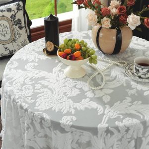 Close-up of floral embroidery and scalloped lace edge