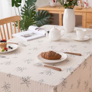 Close-up of floral print and soft cotton texture on a cream-colored tablecloth