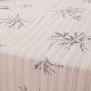 Table setting with cotton botanical tablecloth, porcelain dishes, and fruit