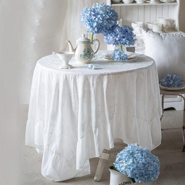 Close-up of floral embroidery details on cotton table linen