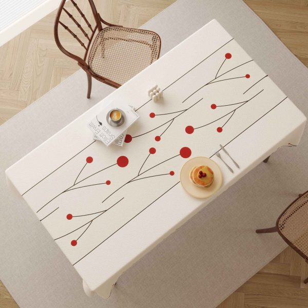 Elegant faux leather waterproof tablecloth with red dotted design, perfect for modern dining spaces and outdoor meals.