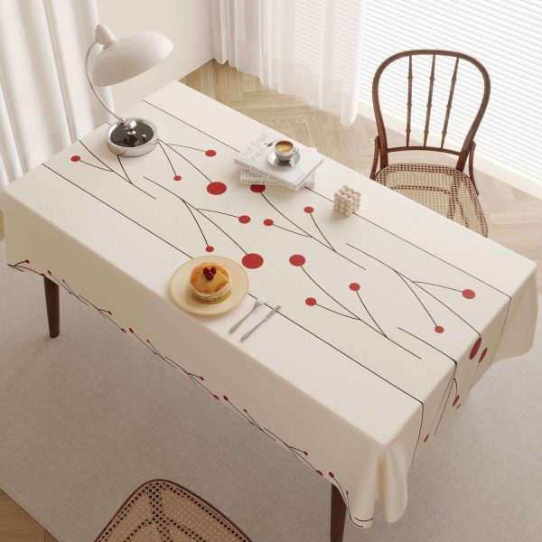 Elegant faux leather waterproof tablecloth with red dotted design, perfect for modern dining spaces and outdoor meals.
