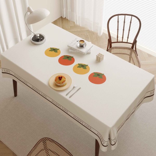 Faux leather tablecloth with persimmon pattern and “HAPPY LIFE” message, designed for easy maintenance and a stylish dining experience.