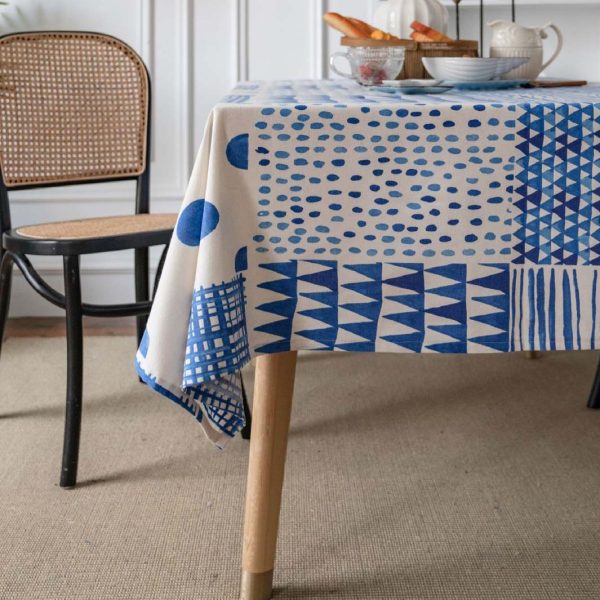 Blue and white geometric cotton-linen tablecloth on a modern dining table, minimalist and elegant style.