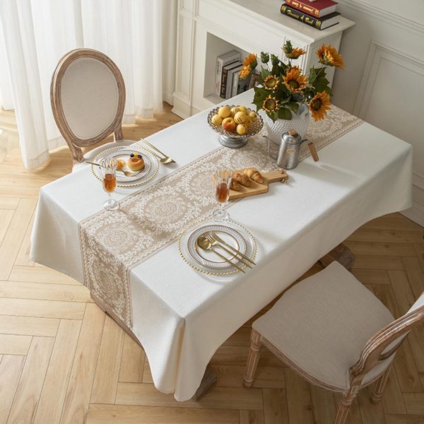 Neutral-toned dining room with rustic wood table and linen-style table cover