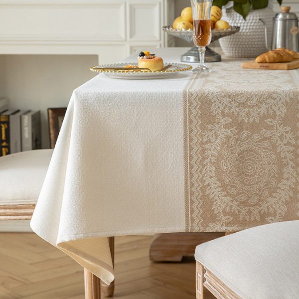 Elegant rectangular table setting featuring natural-toned tablecloth and ceramic dishes