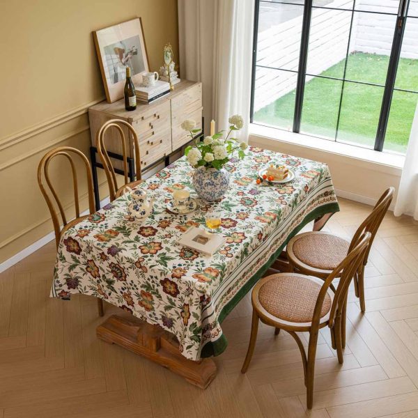 Vintage floral jacquard tablecloth with green border, perfect for rustic or farmhouse-style dining settings