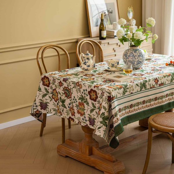 Vintage floral jacquard tablecloth with green border, perfect for rustic or farmhouse-style dining settings