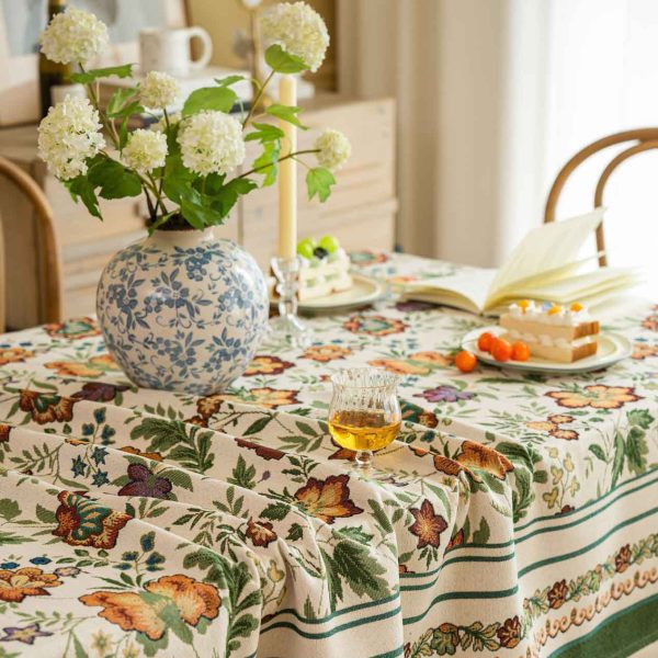 Vintage floral jacquard tablecloth with green border, perfect for rustic or farmhouse-style dining settings