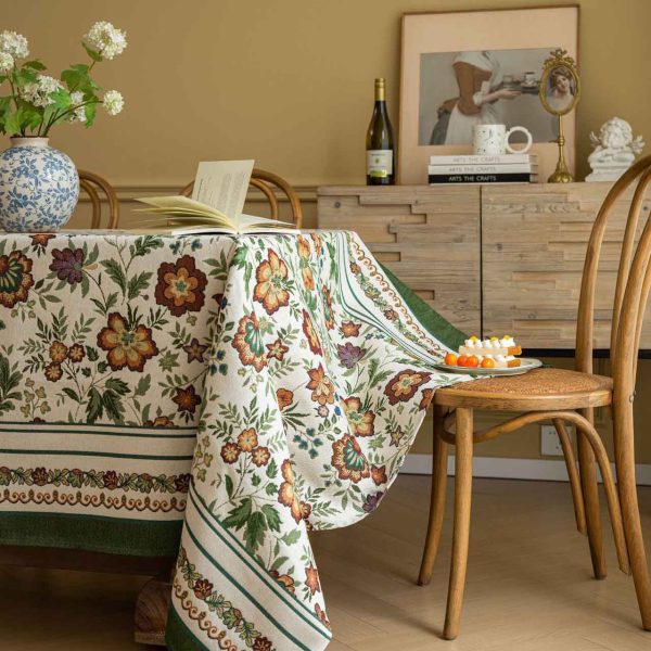 Vintage floral jacquard tablecloth with green border, perfect for rustic or farmhouse-style dining settings