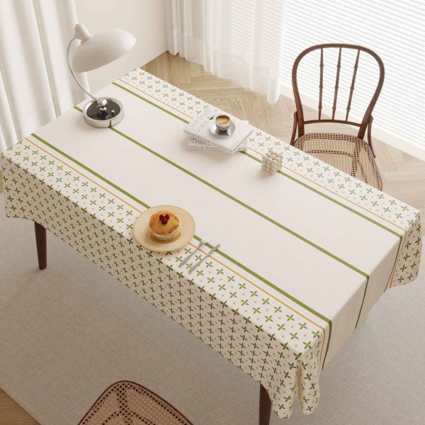 Beige faux leather tablecloth with green striped and floral pattern on rectangle dining table