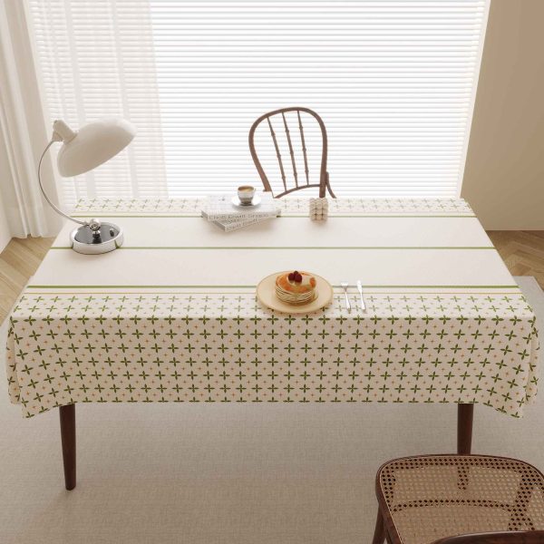 Dining table scene showcasing Beige tablecloth with green stripe detail and cozy charm