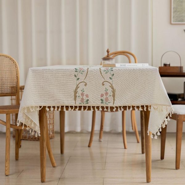 Elegant orchid embroidery detail on lightweight fabric tablecloth