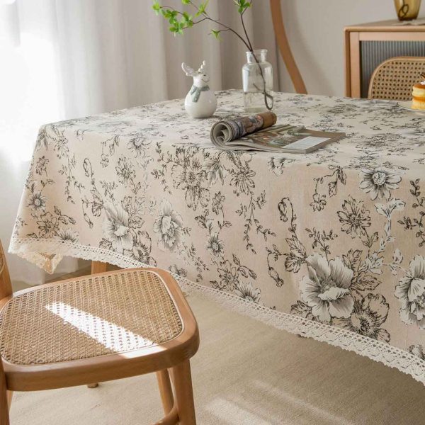 Elegant ivory cotton-linen tablecloth with pink peony floral pattern and white lace trim, styled in a romantic vintage dining setting.