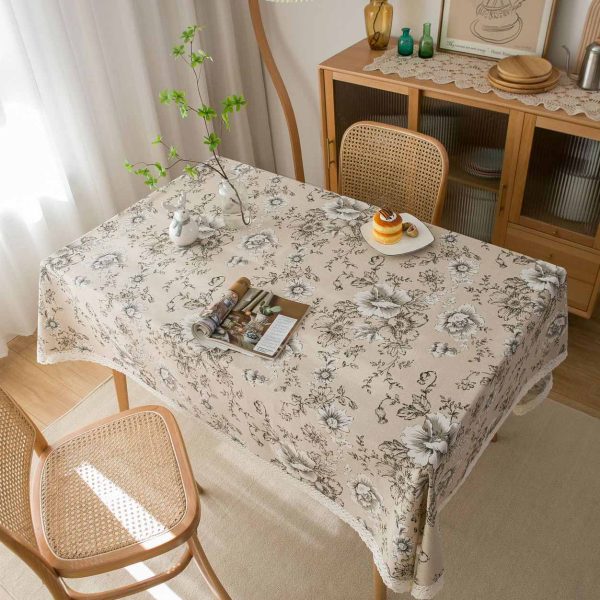 Elegant ivory cotton-linen tablecloth with pink peony floral pattern and white lace trim, styled in a romantic vintage dining setting.
