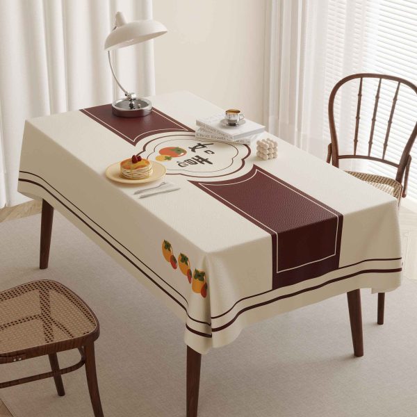 Durable and wipeable beige tablecloth with oil-resistant faux leather surface and cozy brown border.