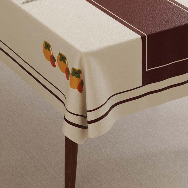 Close-up of wipeable tablecloth surface featuring colorful fruit print on waterproof faux leather material.