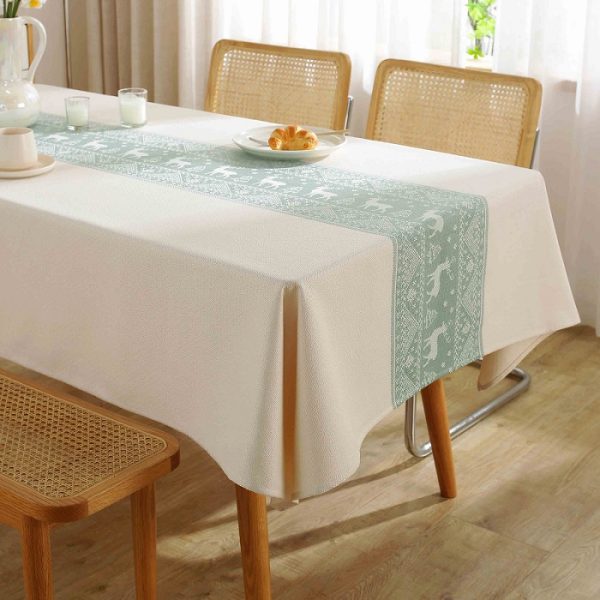 Neutral Nordic tablecloth on wooden table with natural holiday decor