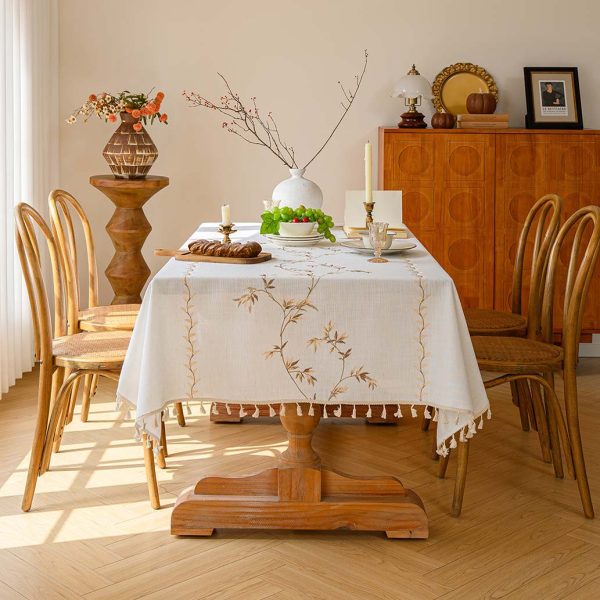 Modern Nordic-style table setting with elegant embroidered tablecloth