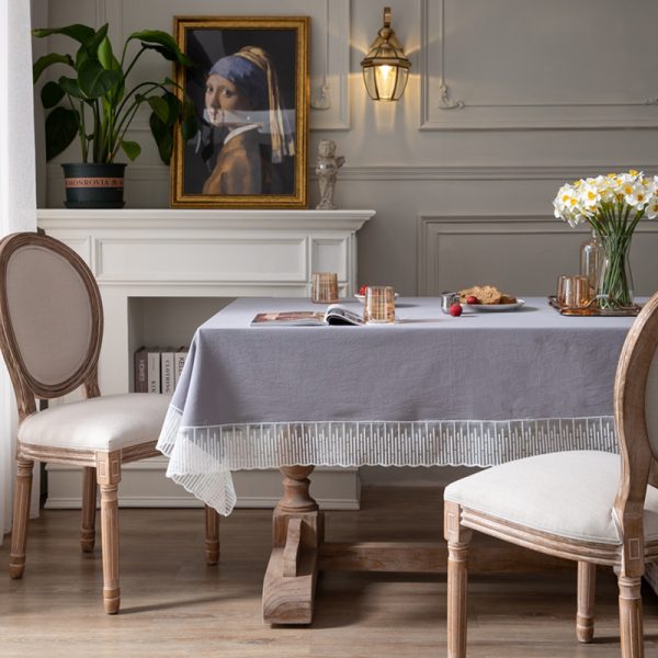 Elegant purple-gray cotton tablecloth with scalloped meteor edges, draped over a modern dining table with natural lighting and minimalist decor.