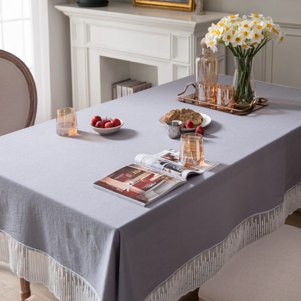 Elegant purple-gray cotton tablecloth with scalloped meteor edges, draped over a modern dining table with natural lighting and minimalist decor.