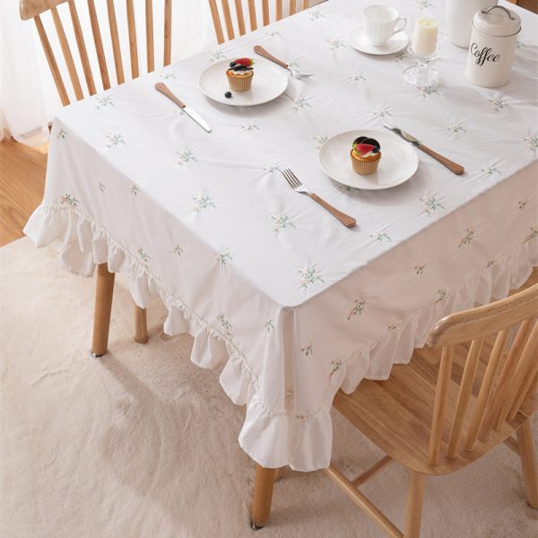 Beige cotton embroidered tablecloth with green leaf pattern and soft ruffle edges, ideal for home dining, outdoor use, or restaurant tables.