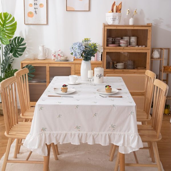 Beige cotton embroidered tablecloth with green leaf pattern and soft ruffle edges, ideal for home dining, outdoor use, or restaurant tables.