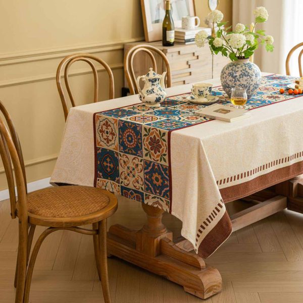 Beige cotton blend tablecloth with Moroccan tile pattern and brown border, featuring jacquard texture and soft tassels – ideal for rustic and bohemian dining rooms.