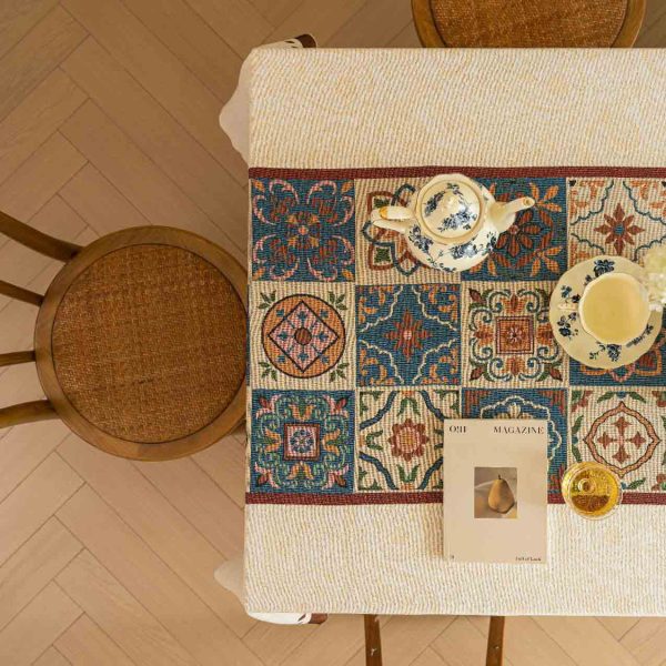 Beige cotton blend tablecloth with Moroccan tile pattern and brown border, featuring jacquard texture and soft tassels – ideal for rustic and bohemian dining rooms.