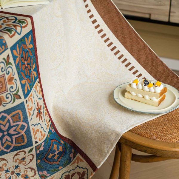 Beige cotton blend tablecloth with Moroccan tile pattern and brown border, featuring jacquard texture and soft tassels – ideal for rustic and bohemian dining rooms.