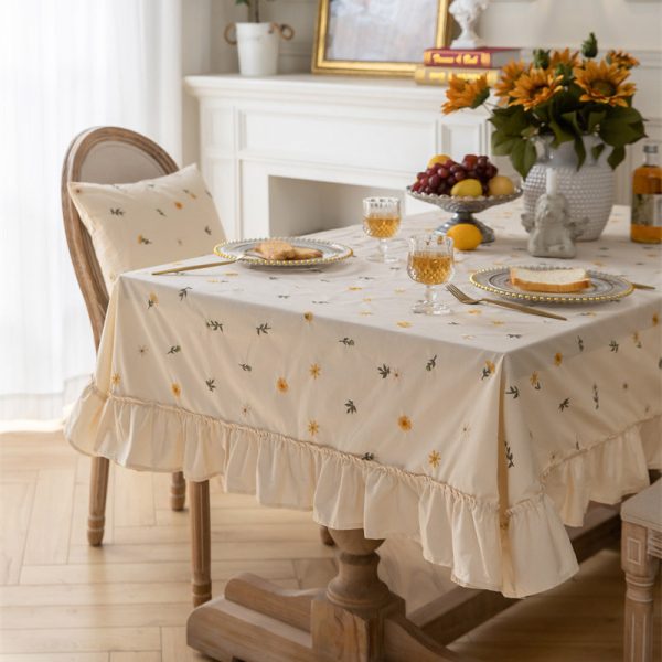 Beige cotton embroidered tablecloth with green leaf pattern and soft ruffle edges, ideal for home dining, outdoor use, or restaurant tables.