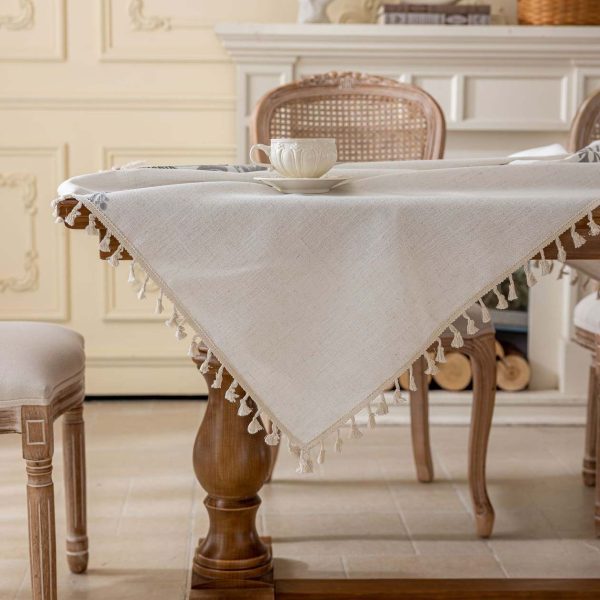 Rectangle table set with embroidered white and gray tablecloth and vintage decor