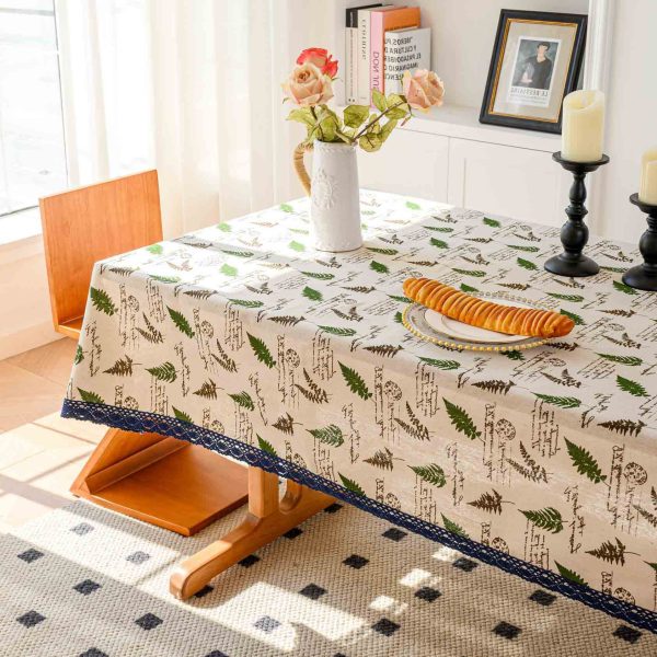 Close-up of natural cotton-linen fabric showing soft botanical print and elegant edging