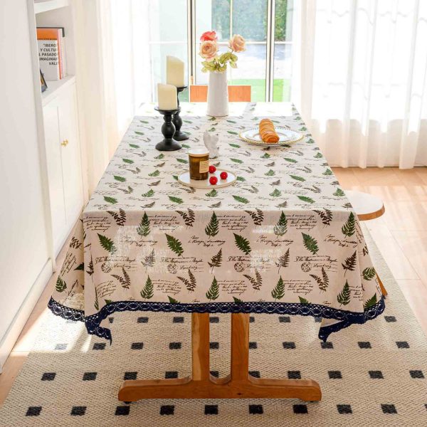 Flat lay of willow print tablecloth with dishes and seasonal floral centerpiece