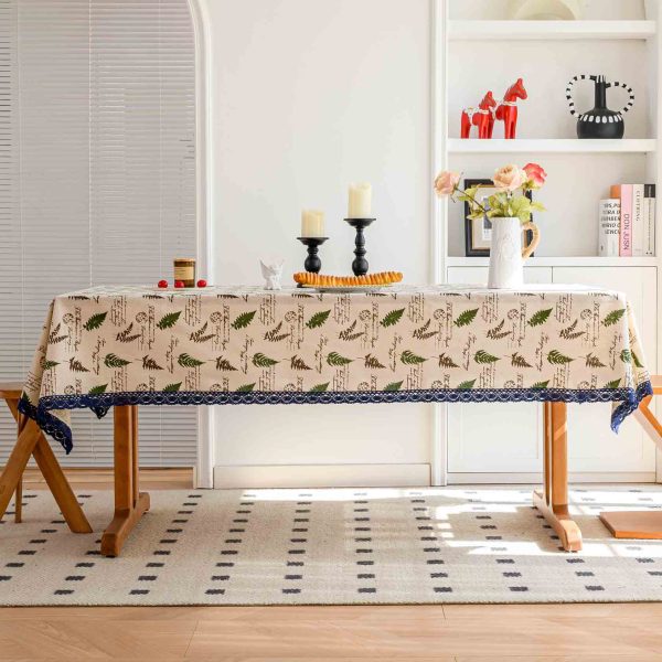 Dining setup with willow leaf tablecloth under warm natural lighting and minimal décor