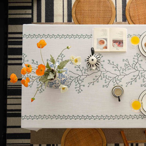Cozy kitchen scene featuring green and white reusable tablecloth