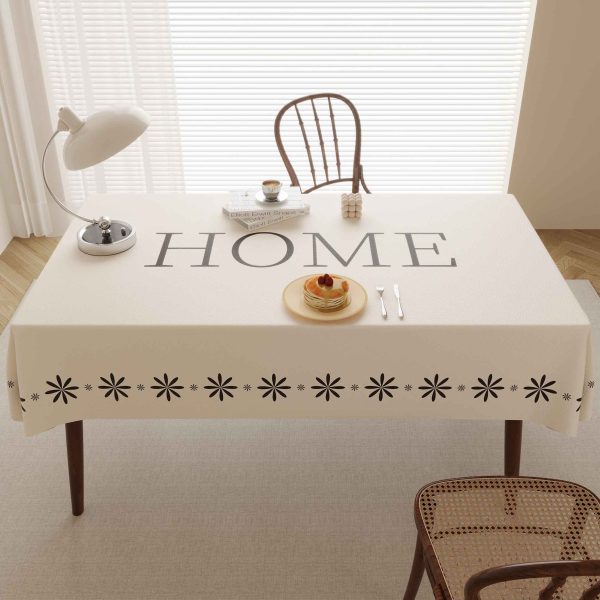 Close-up of wipeable faux leather tablecloth surface showing detailed flower pattern and stitched edge