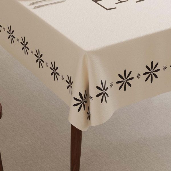 Side angle of beige wipeable tablecloth draping smoothly over table corners