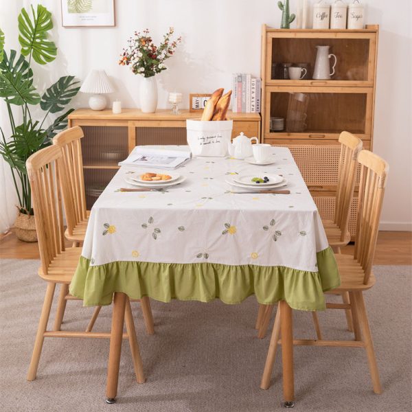 White cotton embroidered tablecloth with lemon and leaf design, featuring green ruffled edges, ideal for summer dining, outdoor picnics, or farmhouse-style kitchens.