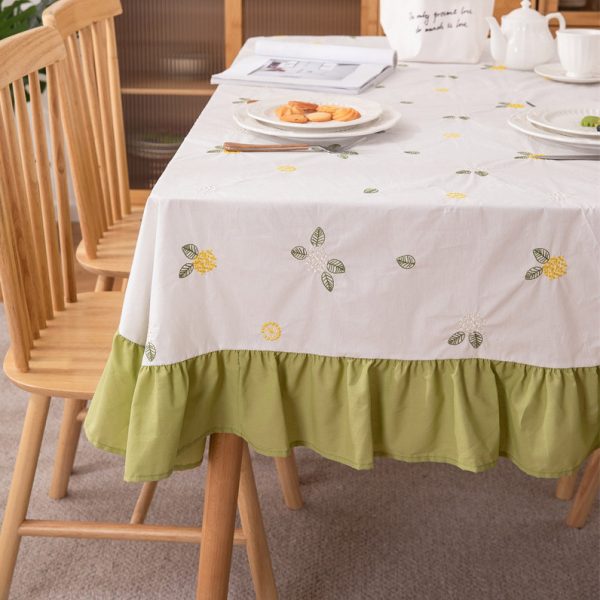White cotton embroidered tablecloth with lemon and leaf design, featuring green ruffled edges, ideal for summer dining, outdoor picnics, or farmhouse-style kitchens.