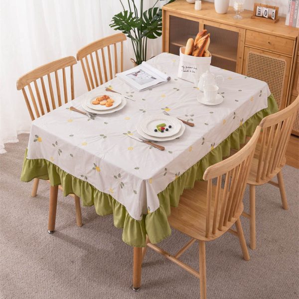White cotton embroidered tablecloth with lemon and leaf design, featuring green ruffled edges, ideal for summer dining, outdoor picnics, or farmhouse-style kitchens.