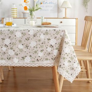 Romantic lace trim tablecloth styled with ceramic plates and greenery centerpiece